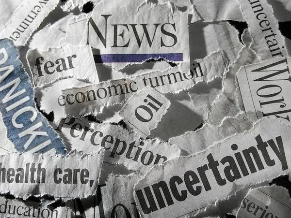 Torn newspaper headlines illustrating uncertainty and market noise